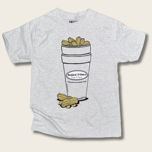 A light heather gray t-shirt featuring a graphic illustration of a styrofoam cup filled with peanuts and a few loose peanuts on the front, set against a light beige background.