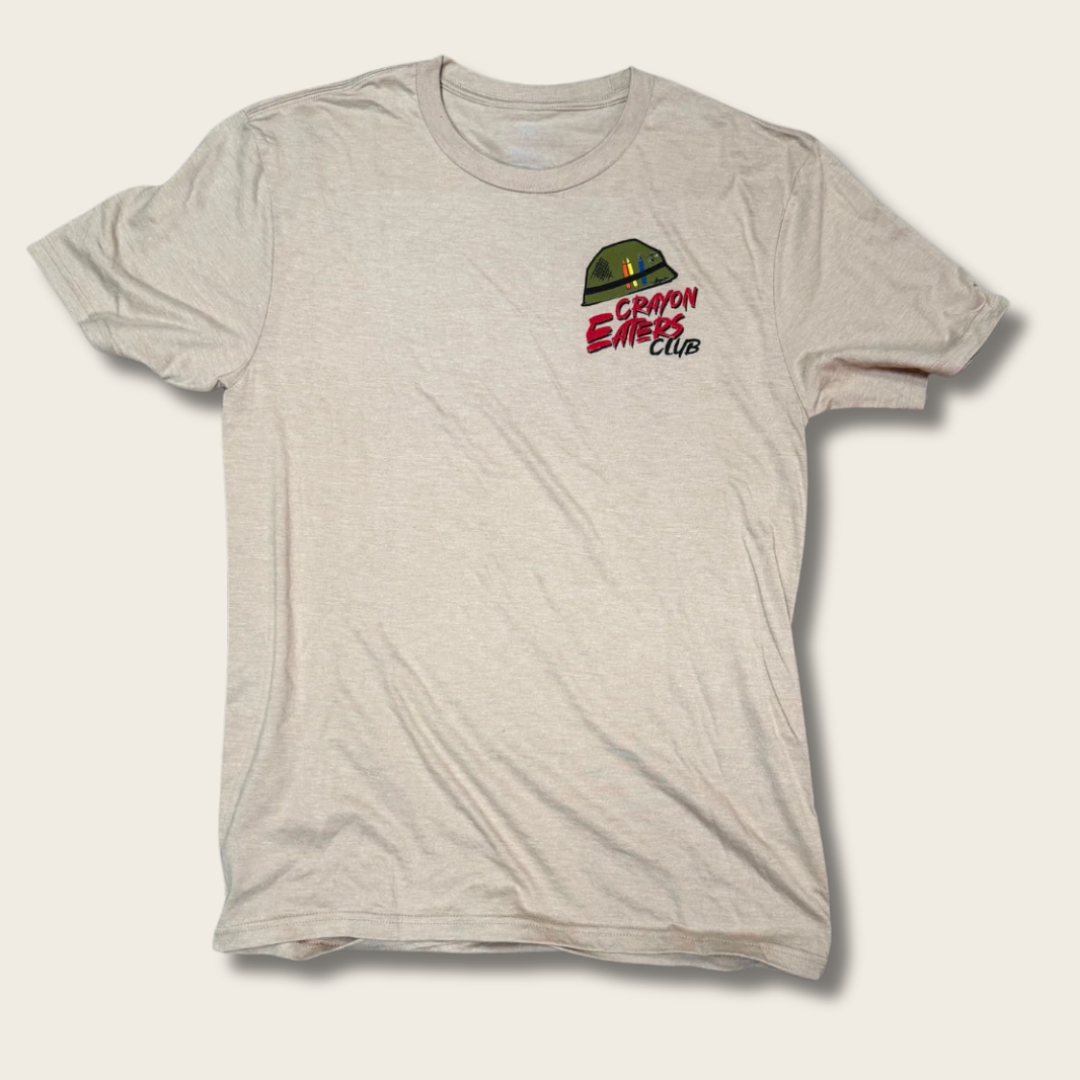 A light heather gray crewneck t-shirt featuring a small chest graphic of a green camouflage dome with the text 'CRAYON ERASED CLUB' in red and black.