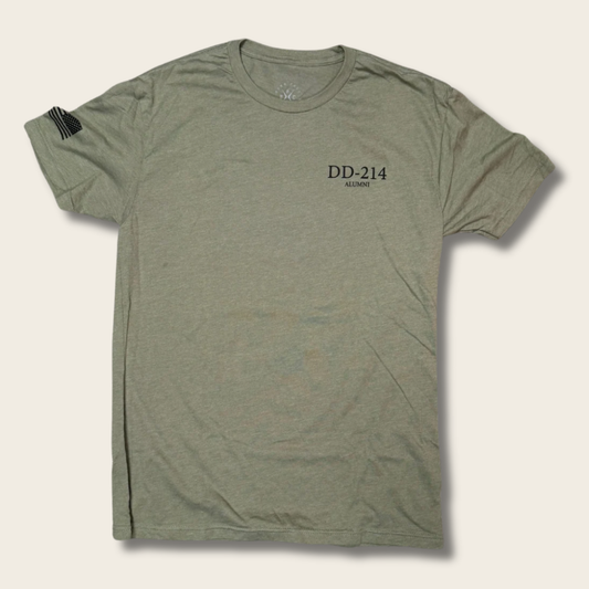 An olive green heathered short-sleeve t-shirt with 'DD-214' and 'MIL-MONT' printed in black on the left chest, displayed flat against a light beige background.