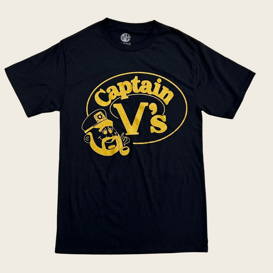 A black short-sleeve t-shirt with a distressed yellow graphic on the front reading 'Captain V's' inside an oval, featuring a cartoon pirate character. The shirt is displayed flat against a white background.