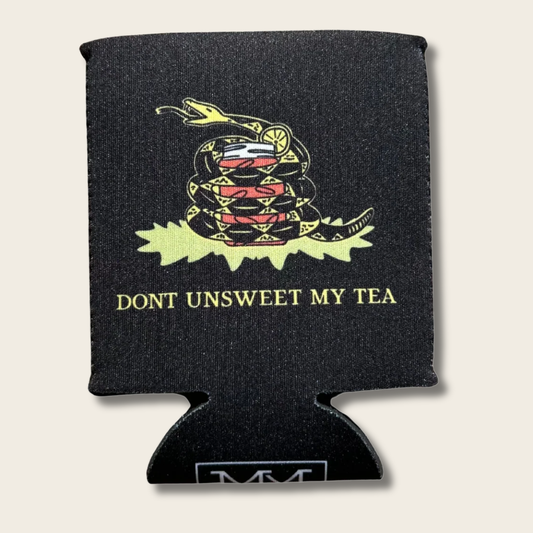 A black can cooler sleeve featuring a coiled rattlesnake graphic with a red, white, and blue flag pattern, a yellow rattlesnake body, and the text 'DONT UNSWEET MY TEA' in yellow. The sleeve is shown on a light beige background.
