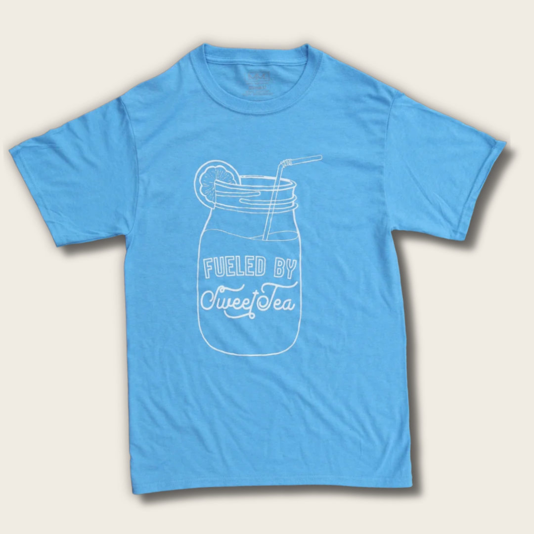 A light blue short-sleeve t-shirt with a white line art graphic of a mason jar filled with iced tea, complete with a straw and lemon slice, and the text 'FUELED BY Sweet Tea' printed on the front.