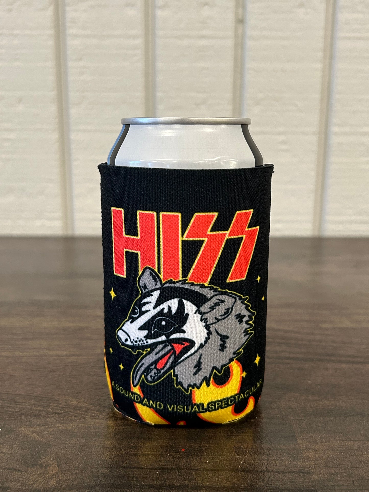 Black can cooler with flames and possum wearing rock makeup with the text HISS
